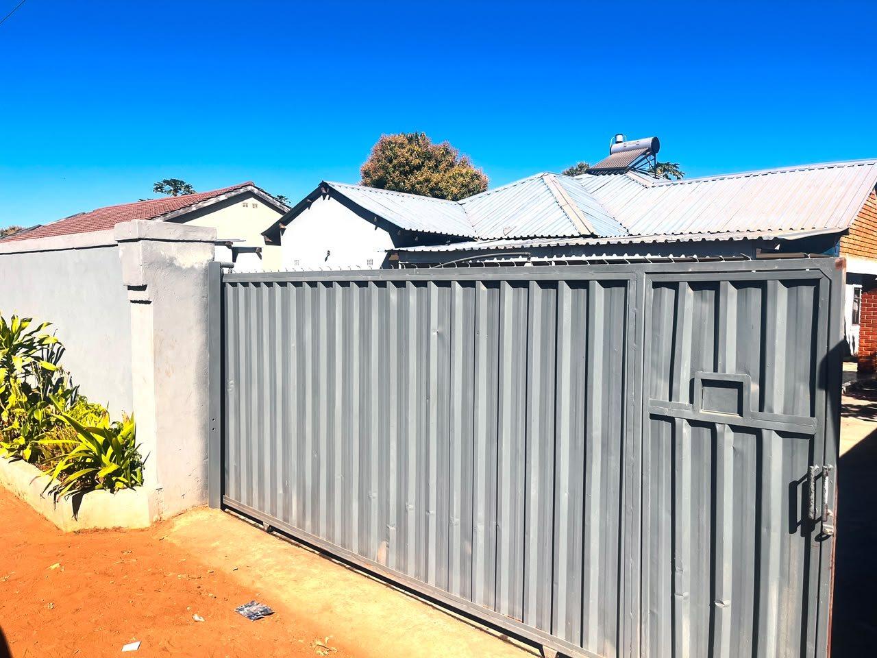 Sliding steel gate and boundary wall at the entrance to Fallsview Guest House